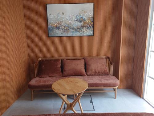 a living room with a couch and a table at Sun Bay Hotel Phu Quoc in Phu Quoc