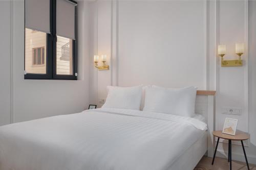 Postel nebo postele na pokoji v ubytování Sweet Home Prime Apart-Hotel
