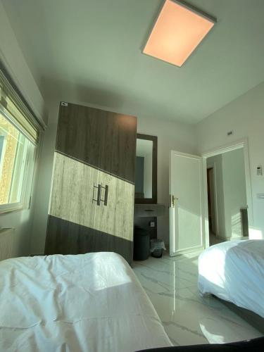 a bedroom with a bed and a wall with the word h at Layal's apartment in Amman