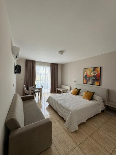 a hotel room with a bed and a couch at Marianna Hotel Apartments in Limassol