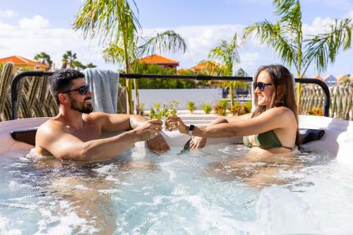 a man and a woman sitting in a hot tub at Casa Blue Marlin (begane grond) in Kralendijk