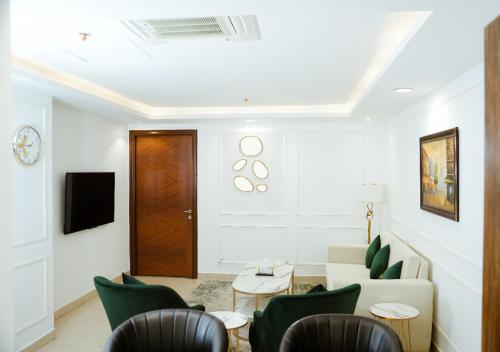 a living room with a couch and chairs at Goldcrest - 1 Bedroom Luxury Apartment - Lahore in Lahore