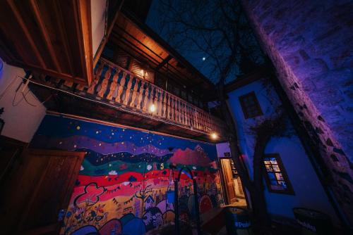 a room with a painting on the side of a building at Kuyu Beergarden Hostel in Antalya