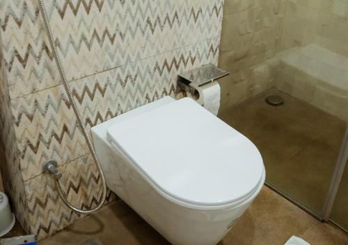 a bathroom with a toilet and a shower at Goldcrest - 1 Bedroom Luxury Apartment - Lahore in Lahore