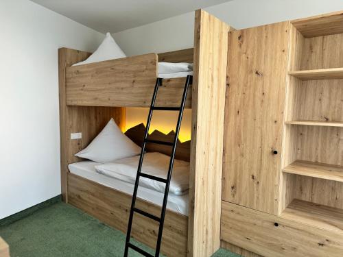 a bunk bed with a ladder in a room at Wellness-& Nationapark Hotel Schliffkopf, BWSC in Baiersbronn