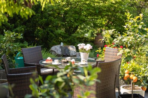 a table and chairs with food and flowers on it at Hotel Burgblick in Badenweiler