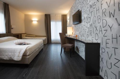 a hotel room with a bed and a desk at Miramonti Park Hotel in Bormio