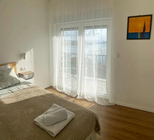 Postel nebo postele na pokoji v ubytování Apartmani Portina