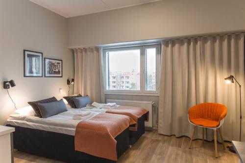 a hotel room with a bed and a window at Forenom Aparthotel Espoo Leppävaara in Espoo