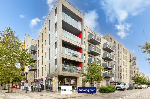 an apartment building with balconies on a city street at Last-Minute Secure l Sleeps Up to 8 l 2 Bedroom Apt By Capital Retreats Short Lets & Serviced Accommodation London With Balcony, Free WiFi in Colindale