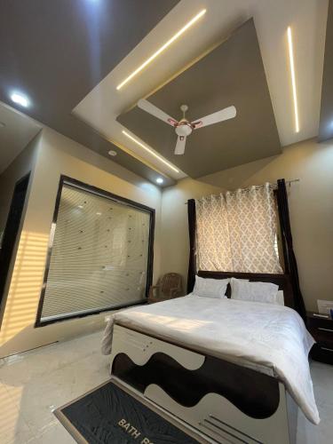 a bedroom with a bed with a ceiling fan at The Bourbon Estate in Mahirāvani