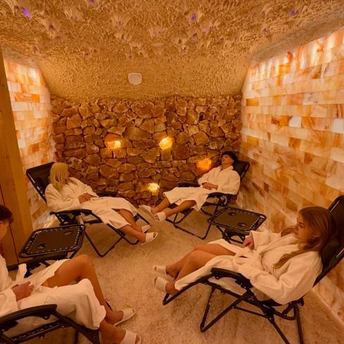 a group of women sitting in chairs in a room at Hotel Zelený dům in Dolní Poustevna
