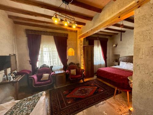 A bed or beds in a room at Avanos Suites