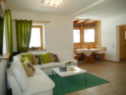 a living room with a white couch and a table at Blackforest Life in Urberg