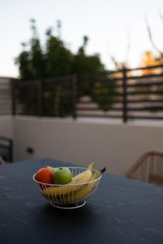a bowl of fruit sitting on top of a table at Beach Luxury Homes - Zoe in Lampi