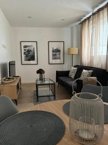 a living room with a couch and a table at VTZ Los Balcones del Casco in Zaragoza