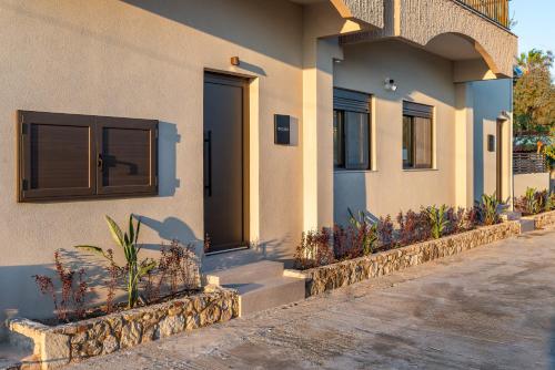 a house with a door and some plants in front of it at Beach Luxury Homes - Zoe in Lampi