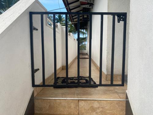 a stairway with a black metal gate on a building at Coastal Heaven in Bentota