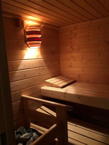 a wooden sauna with a bed and a lamp at Ruhig und Zentral in Unterschächen