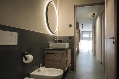 a bathroom with a sink and a mirror at Haunold Homes in San Candido