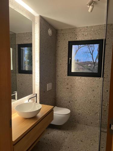 a bathroom with a sink and a toilet and a mirror at Vila Solini in Kozana