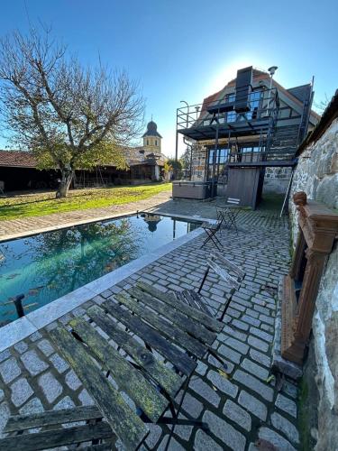 a swimming pool with a house in the background at DVOR 13 Hokovce in Hokovce