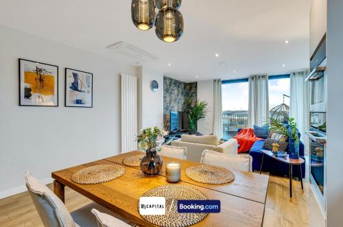 a dining room with a table and a living room at Last-Minute Grabs l Cozy Apt in Camden Town By Capital Retreats Short Lets & Serviced Accommodation London With Balcony, Free WiFi in London