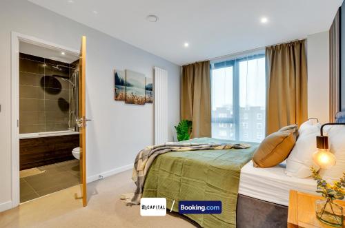 a bedroom with a bed and a walk in shower at Last-Minute Grabs l Cozy Apt in Camden Town By Capital Retreats Short Lets & Serviced Accommodation London With Balcony, Free WiFi in London