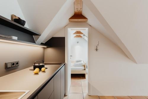 a kitchen with white cabinets and a white door at Quartier Carpe Diem in Prerow