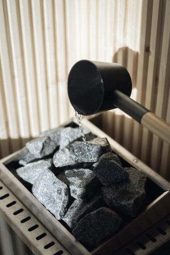 a spatula dropping rocks into a bin of rocks at Haunold Homes in San Candido