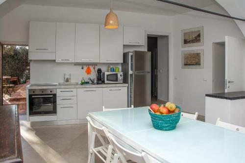 a kitchen with a table with a bowl of fruit on it at Le terrazze sul mare in Chiavari