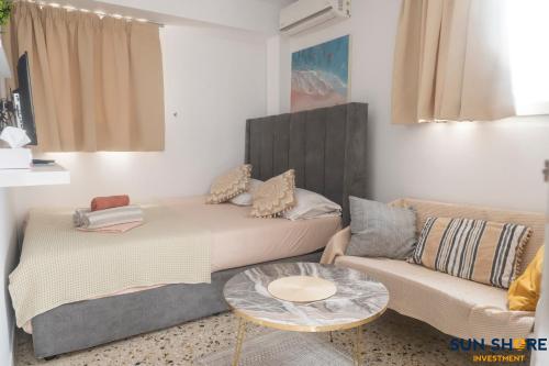 a living room with a couch and a table at Explore Greece from Cozy City Centre Apartment in Chalkida