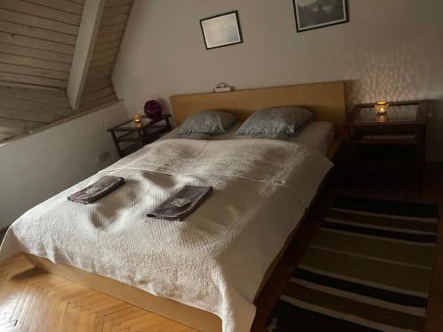a bedroom with a bed with two towels on it at GreenPark Garden Villa Family Apartments Near Tokaj in Szerencs