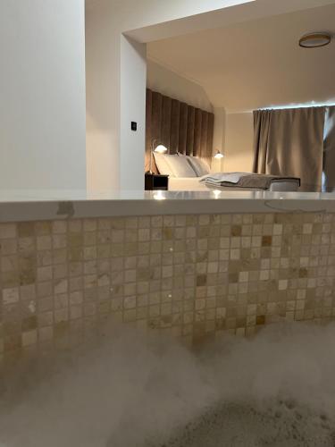 a view of a hotel room with a bed and a mirror at Vila Slavonika in Slavonski Brod