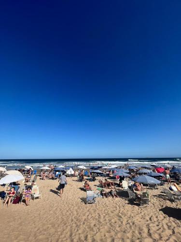 a group of people sitting on the beach at Departamento en Punta del Este in Punta del Este
