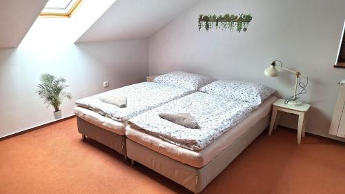 a bedroom with a bed and a lamp in it at Penzion Johannes, Rýmařov - Stará Ves in Stará Ves
