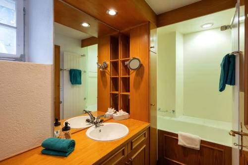 a bathroom with a sink and a mirror at Chesa Madrisa#13 in Klosters