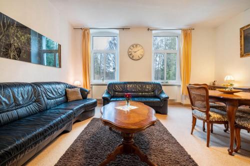 a living room with a couch and a table at Kolbatzer Mühle in Lychen