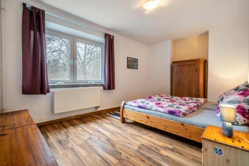 a bedroom with a bed and a window at Kolbatzer Mühle in Lychen