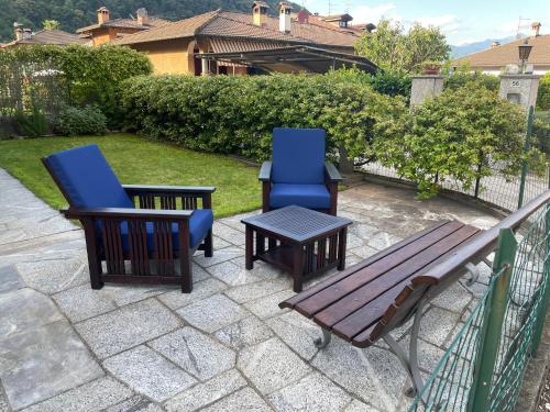 two chairs and a table and a bench on a patio at Gila's Home Camera matrimoniale in appartamento condiviso in Cannobio