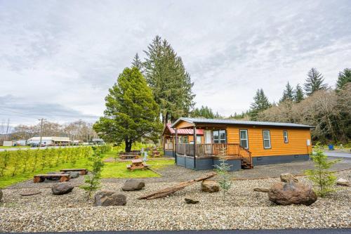 a cabin in a field with a yard with trees at Rainforest Tiny Home Retreat #30 in Forks