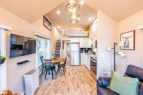 a kitchen and living room with a table and chairs at Rainforest Tiny Home Retreat 29 in Forks