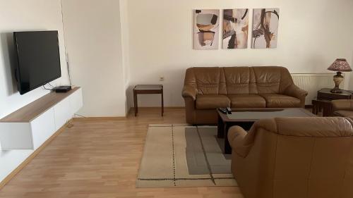 a living room with a couch and a flat screen tv at BT Lux apartment 2 in Skopje
