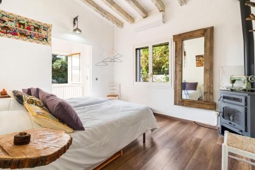 a bedroom with a bed and a table in a room at ツ Villa Carrasca l Luxe l Vista al Mar l Piscina Climatizada l Nature in Arenys de Munt