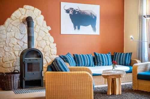 a living room with a couch and a fireplace at Kolbatzer Mühle in Lychen