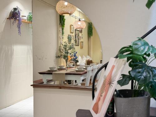 a dining room with a table and a mirror at 3 Bedroom NORDIC HOME Full Kitchen 8 MINS to MRT & JODD Fair & near RCA in Bangkok