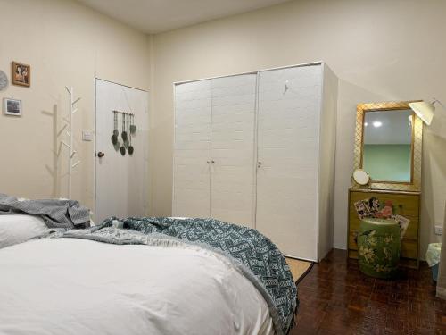 a bedroom with a bed and a mirror at 3 Bedroom NORDIC HOME Full Kitchen 8 MINS to MRT & JODD Fair & near RCA in Bangkok