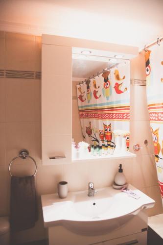 a bathroom with a sink and a mirror at Ιasonas Apartment in Nafplio