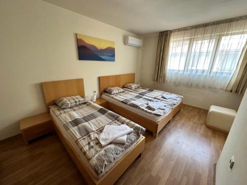 a room with two beds and a window at Top Lodge twobedroom apartment in Bansko