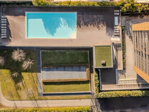 an overhead view of a house with a swimming pool at Giax Tower-Pool,Spa&Gym-Niguarda Hospital-10min to Duomo in Milan